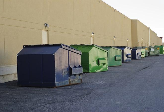 a collection of bright and vibrant dumpsters in a construction zone in Joshua Tree, CA